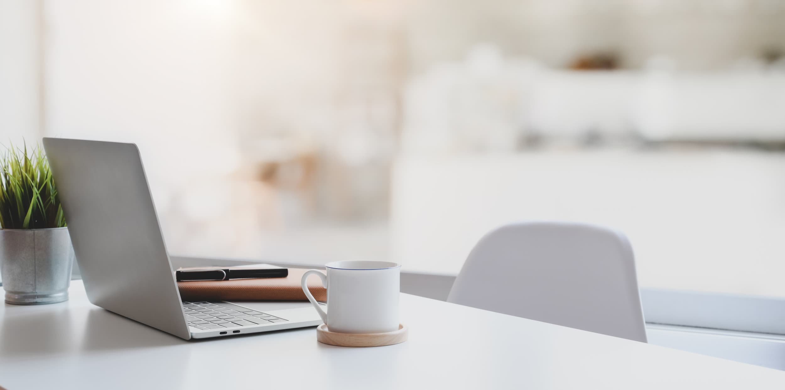 Modern comfortable workplace with laptop computer, coffee cup and office supplies